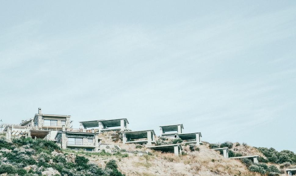 Free Image of Hillside homes against a cloudy sky 
