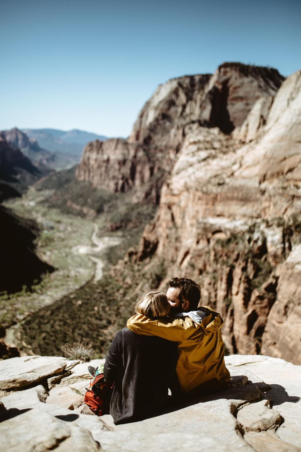 Free Image of Couple enjoying a breathtaking cliff view 