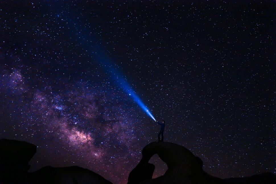 Free Image of Person holding torch under starry sky 