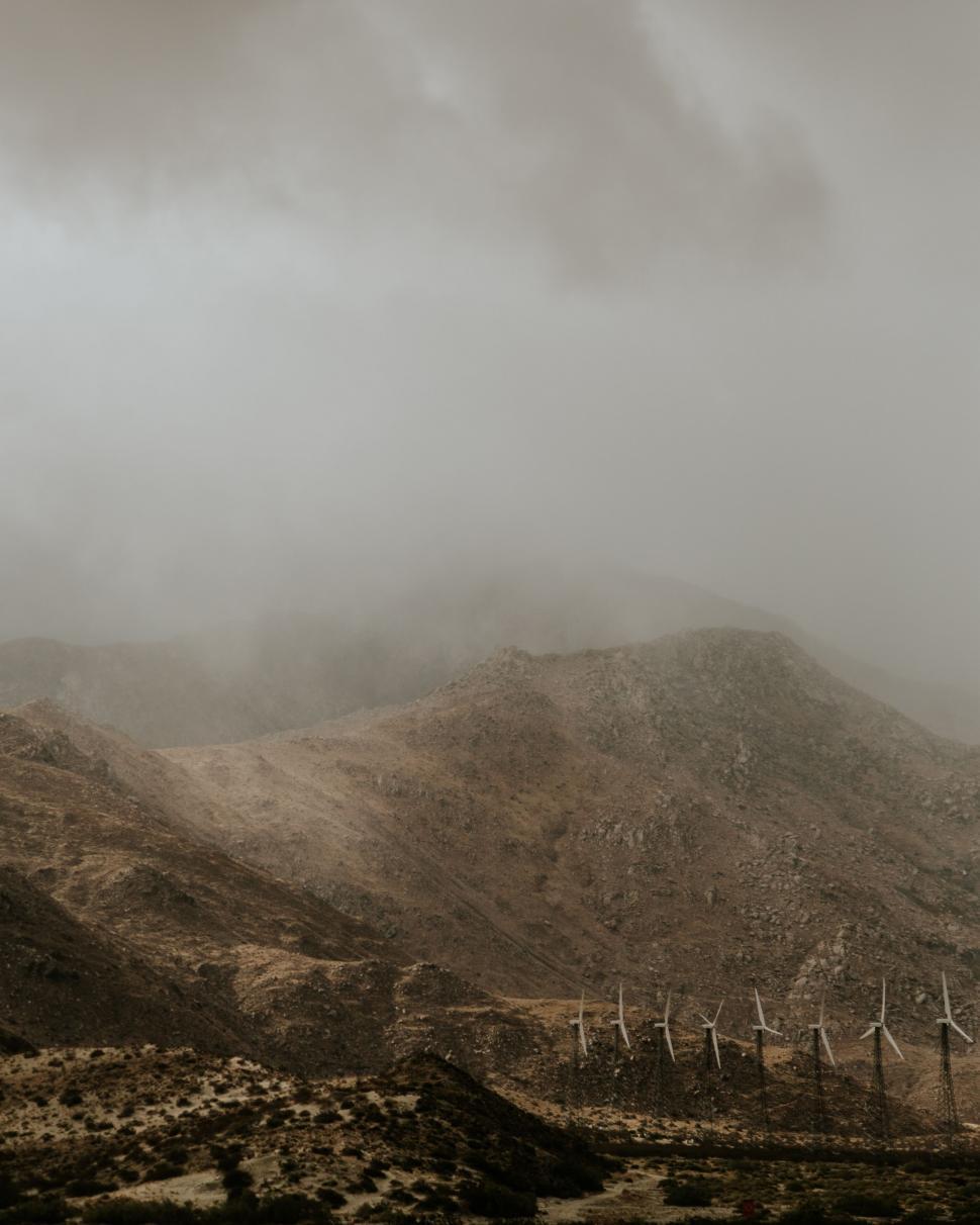 Free Image of Moody mountainscape with wind turbines 