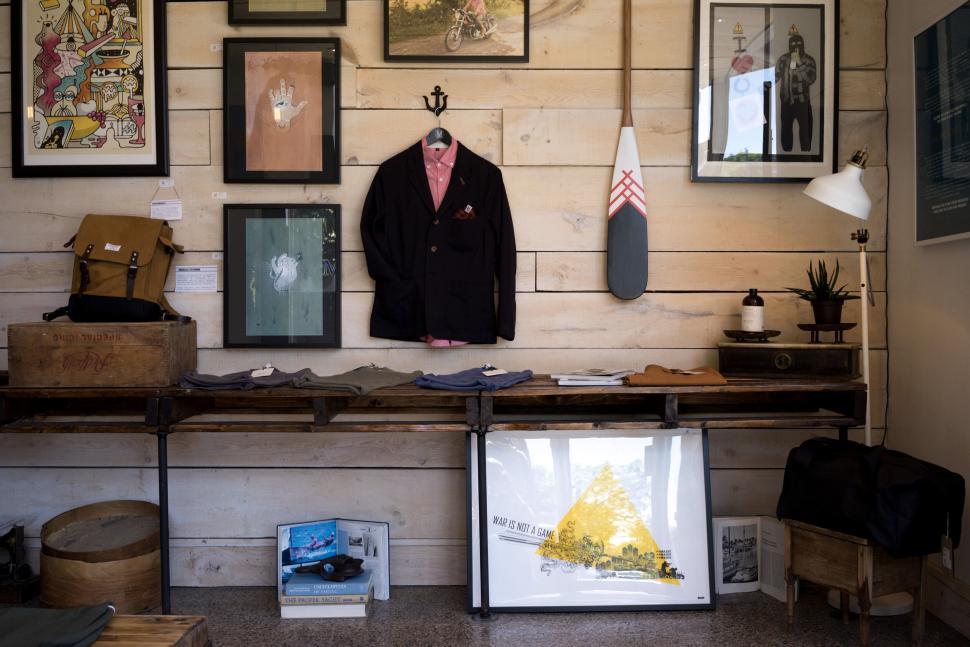 Free Image of Modern wall art and vintage clothes in a shop 