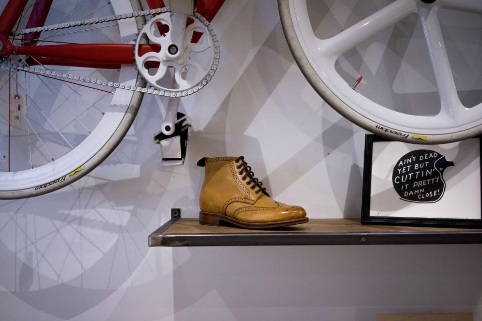 Free Image of Brown leather boot on display shelf with bikes 