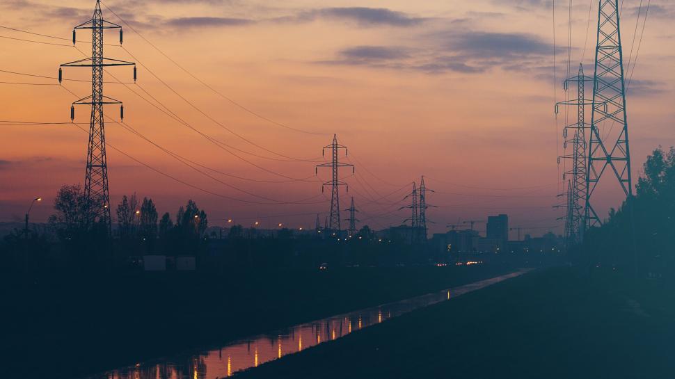 Free Image of Electric towers and sunset by the river 
