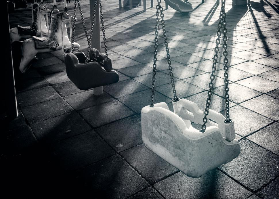 Free Image of Empty swings at a playground in monochrome 
