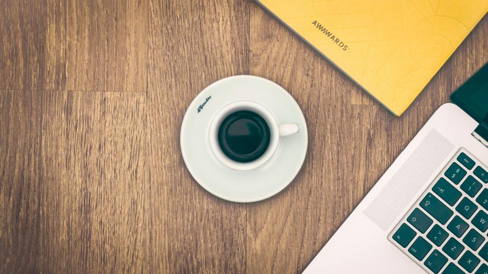 Free Image of Coffee cup and laptop on a wooden table 