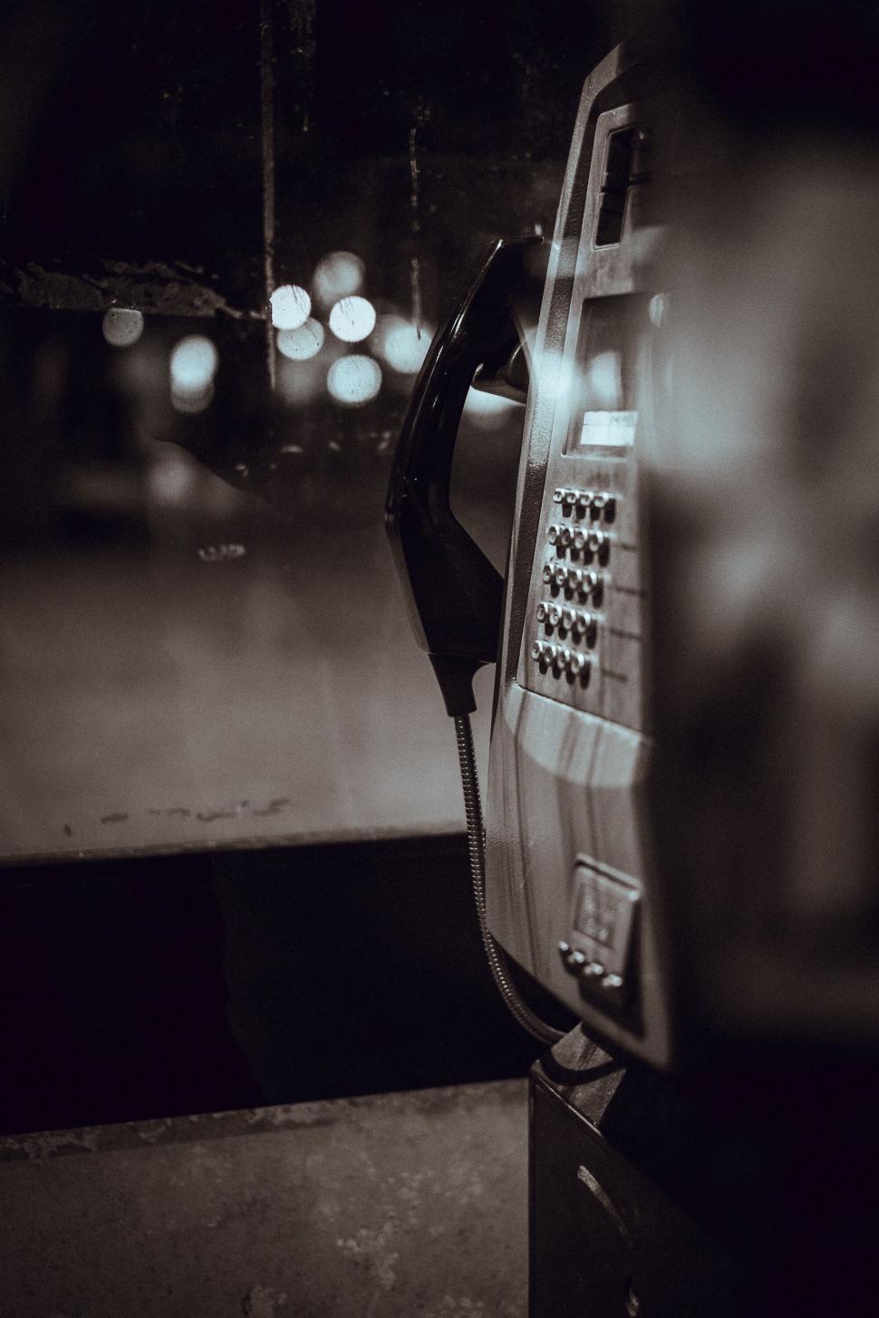 Free Image of Vintage payphone in a dark surrounding 