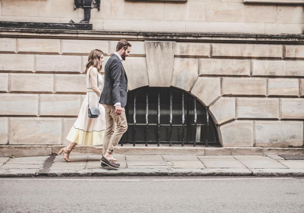 Free Image of Elegant Couple Walking Beside Building 