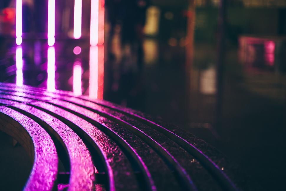 Free Image of Rain-wet bench under city lights at night 