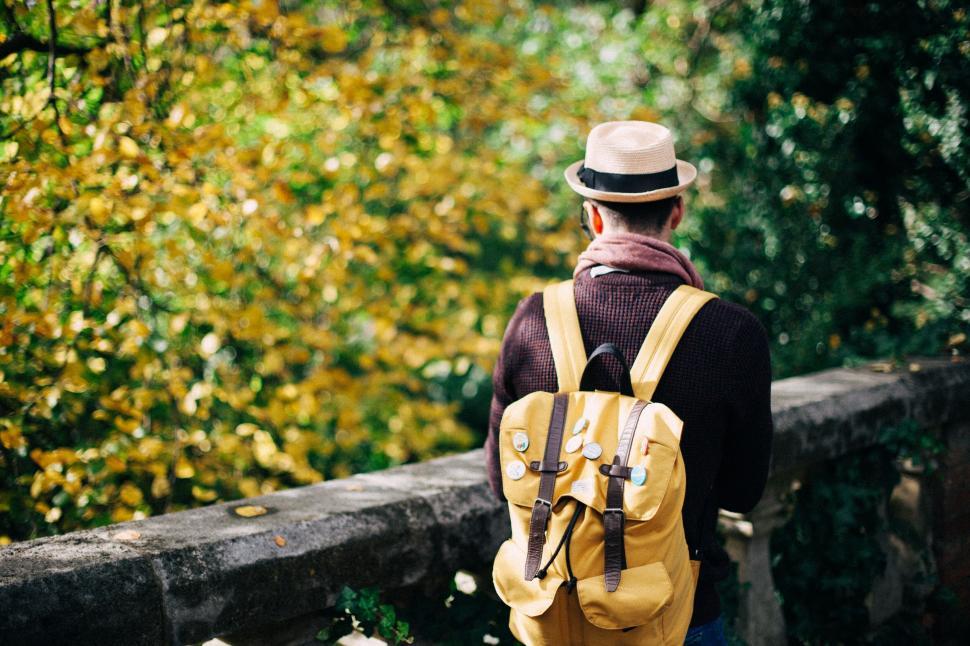 Free Image of Man in hat with backpack contemplating nature 