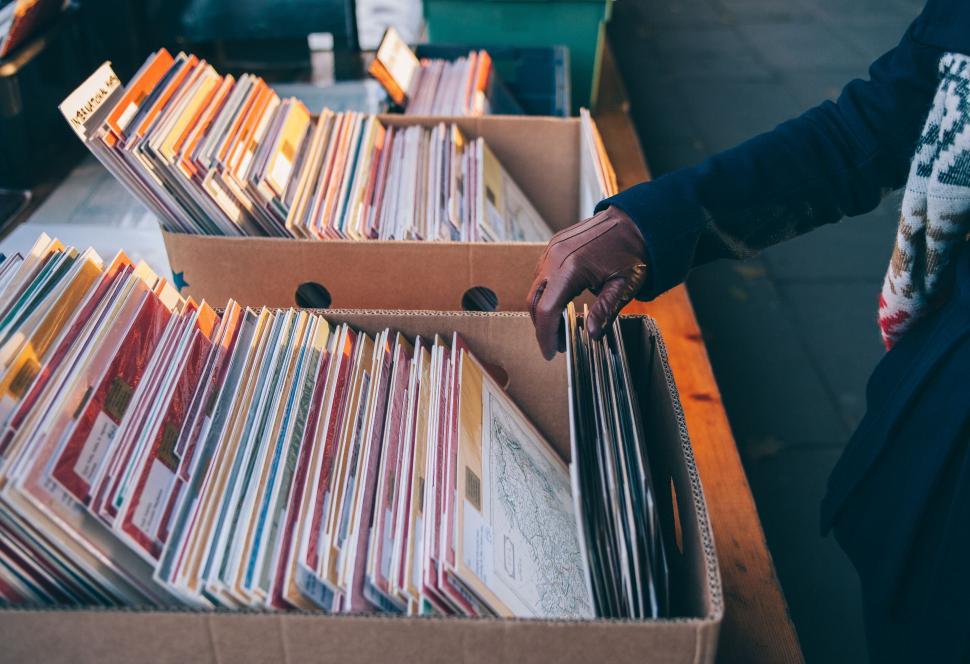 Free Image of Person browsing records at a street market 