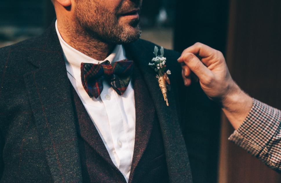 Free Image of Man adjusting bow tie at event 