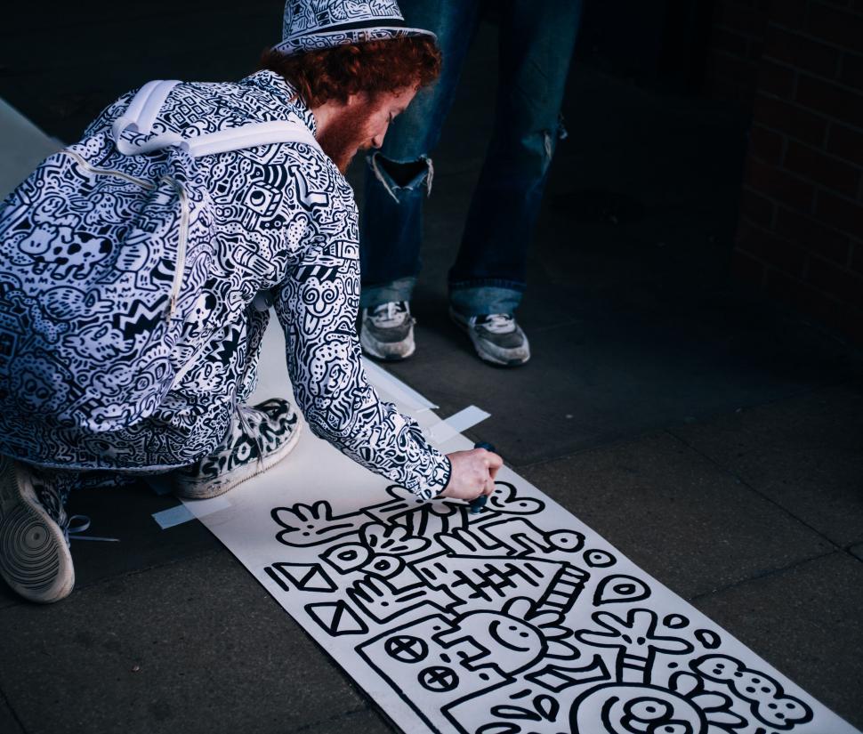 Free Image of Artist creating a street art doodle mural 