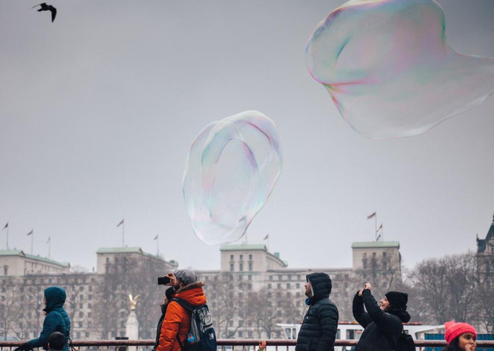 Free Image of Giant bubble floating above a crowd 