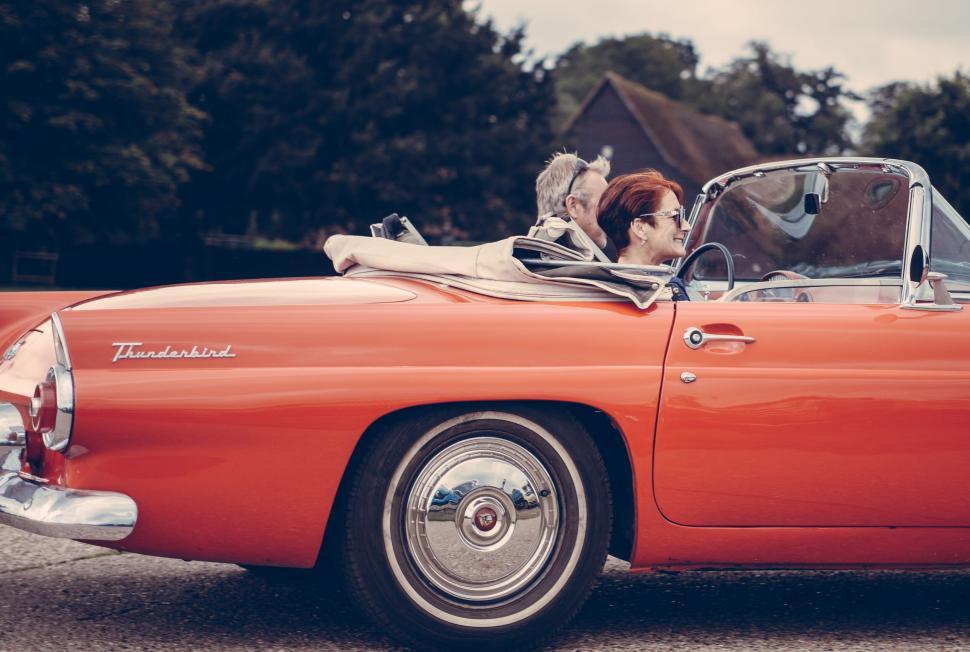 Free Image of Vintage car with couple enjoying a drive 