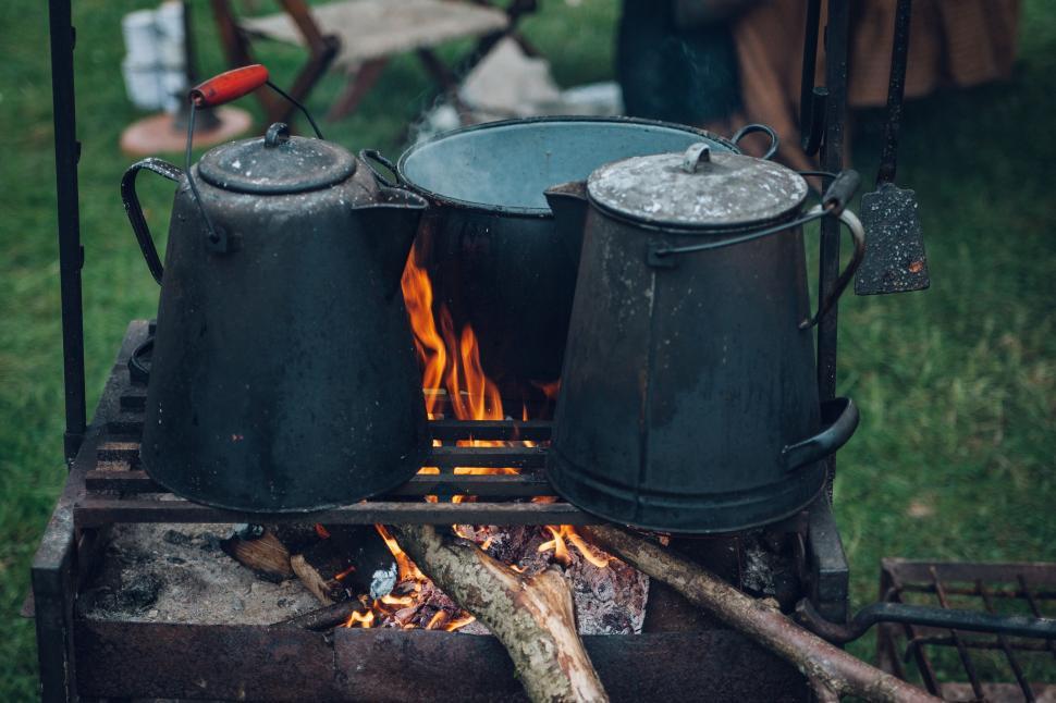 Free Image of Kettles over a campfire cooking 
