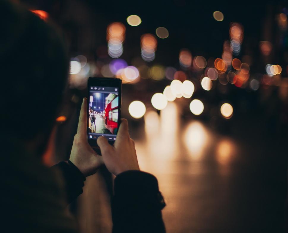 Free Image of Smartphone capturing blurry street 