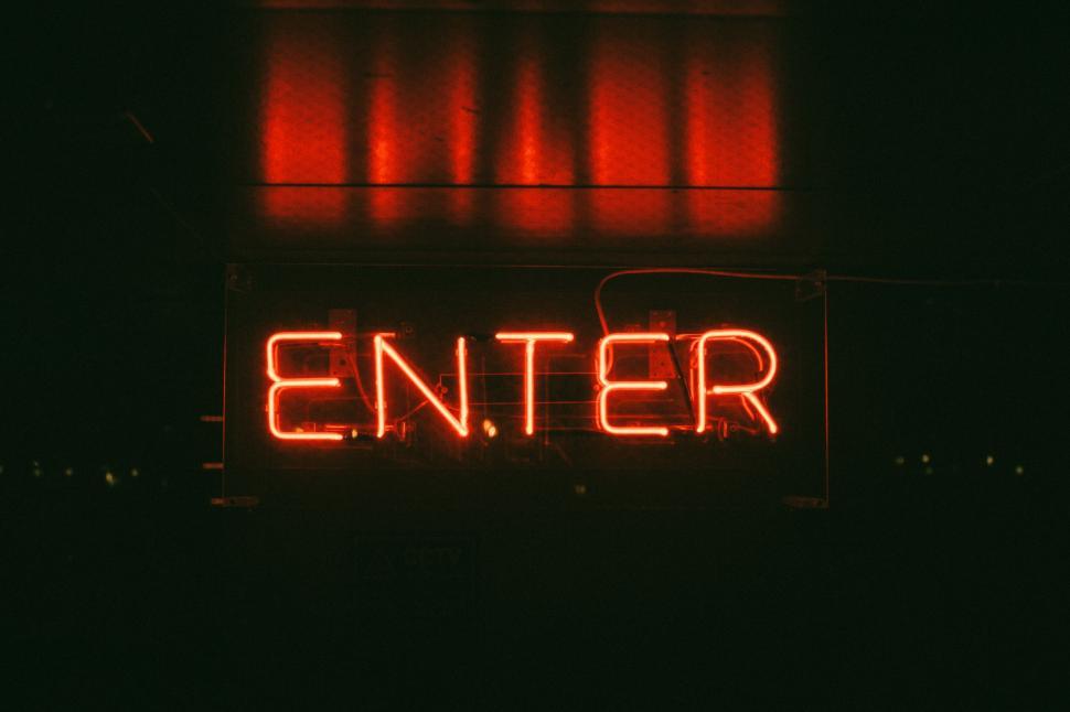 Free Image of Red neon sign spelling  Enter  at night 