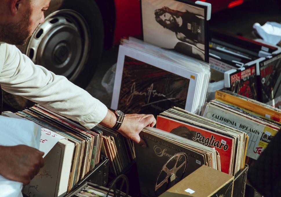 Free Image of Person browsing through vinyl records at a market 