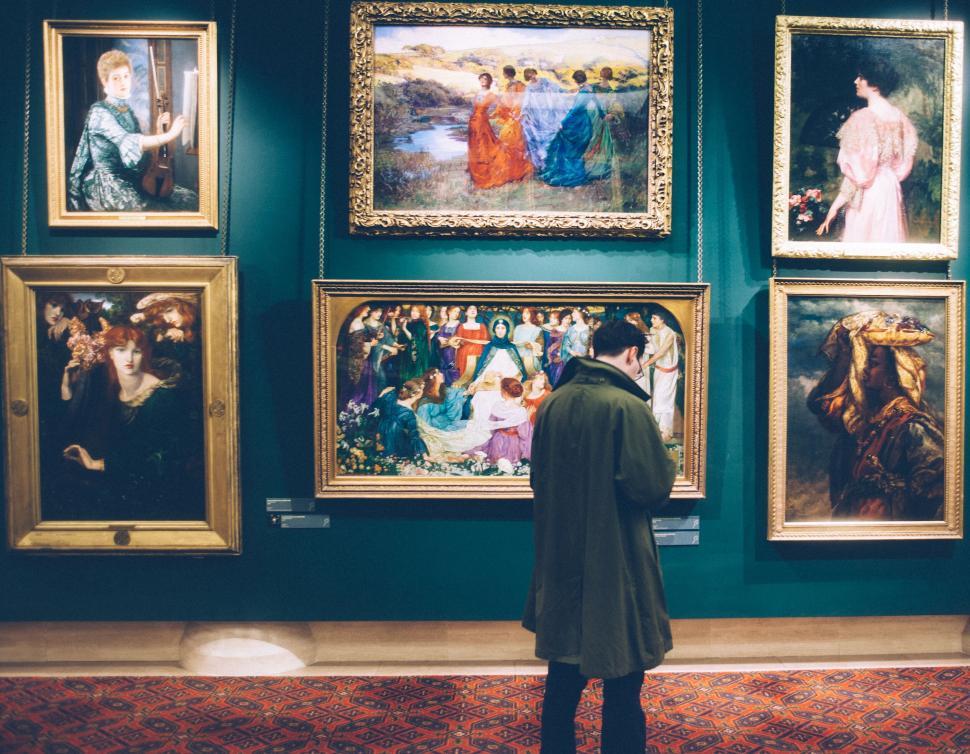 Free Image of Person viewing paintings in a gallery 