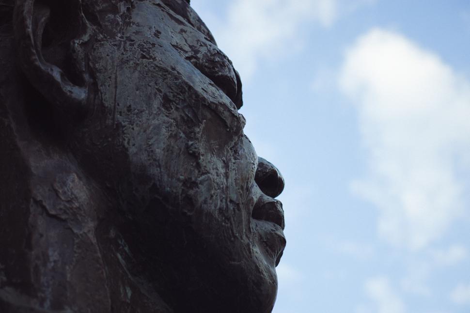 Free Image of Close-up of a textured bronze statue face 