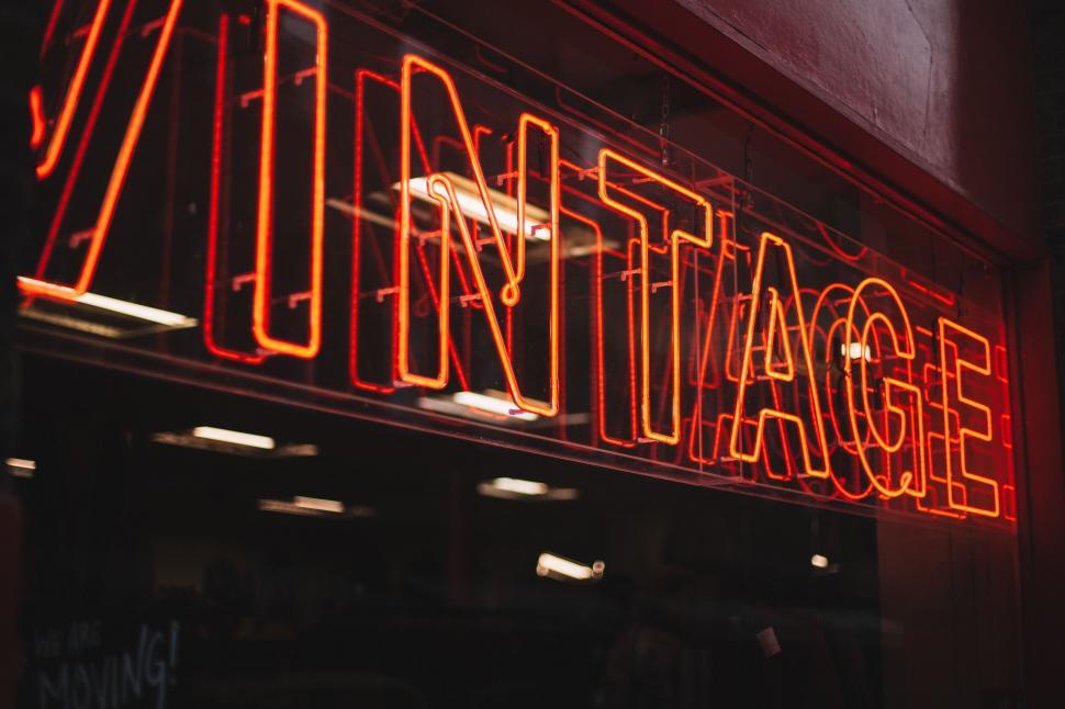 Free Image of Neon sign reading  Vintage  on a brick wall 