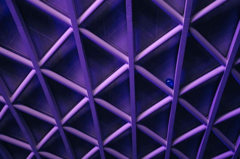 Free Image of Abstract interlocking ceiling pattern in purple tones 