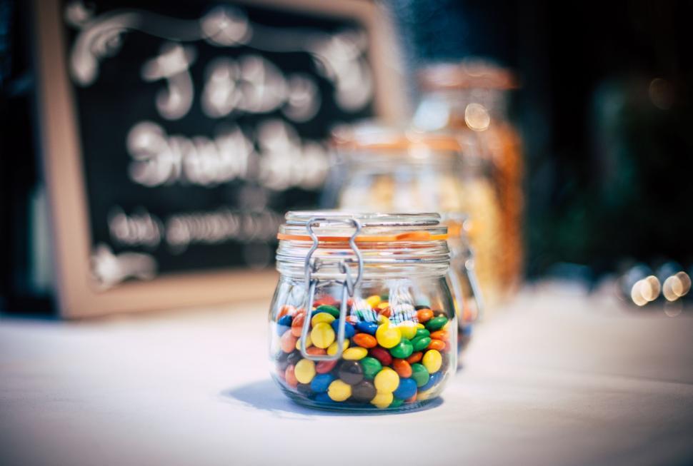Free Image of Colorful candies in glass jars on display 