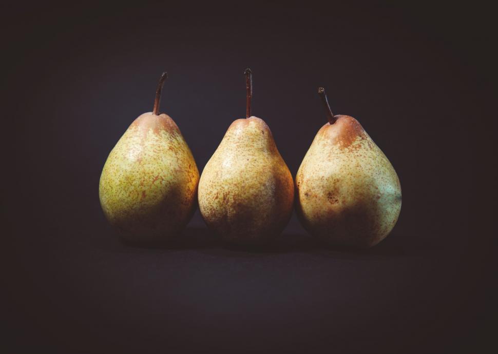 Free Image of Three ripe pears on dark background 