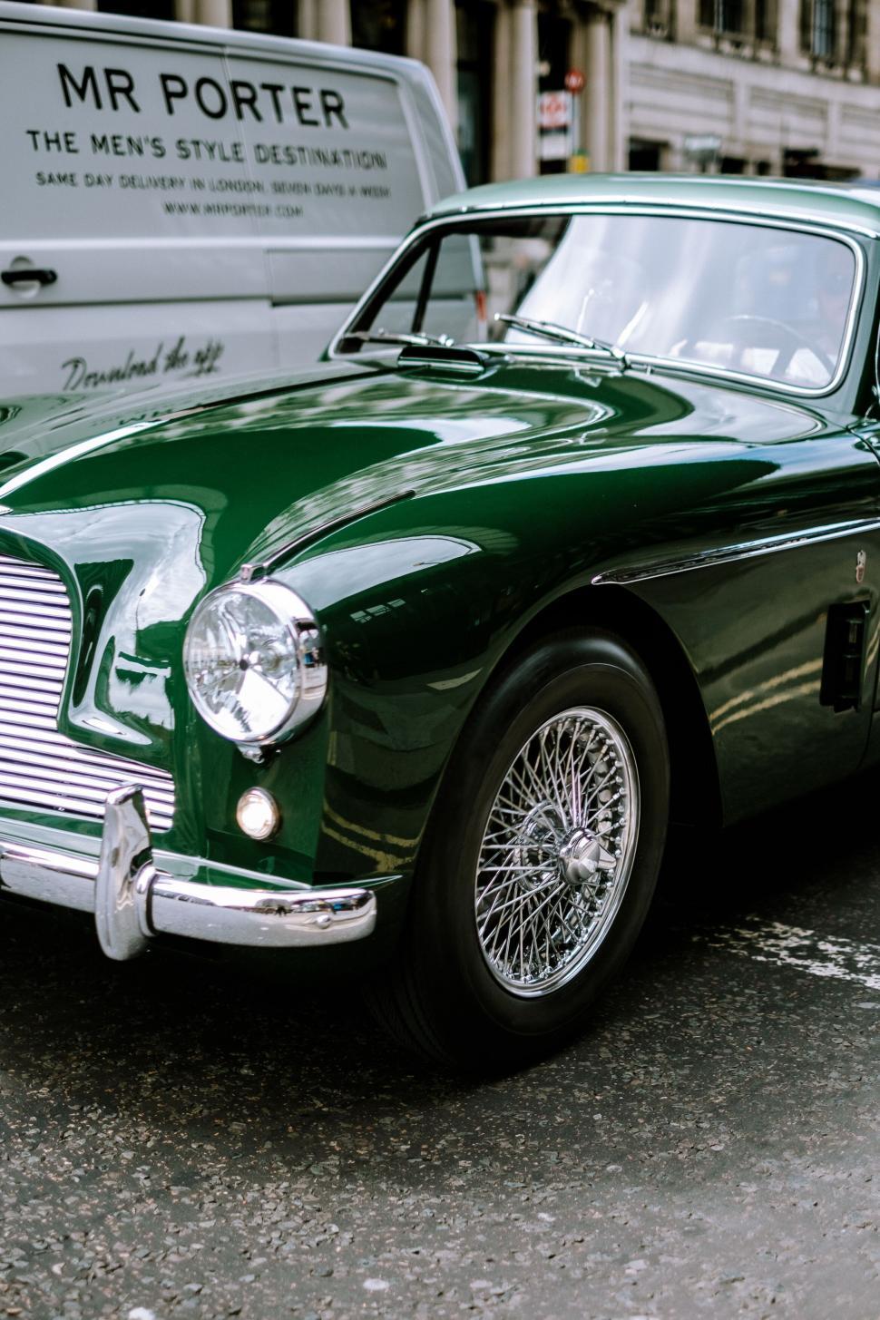 Free Image of Classic green Aston Martin on urban street 