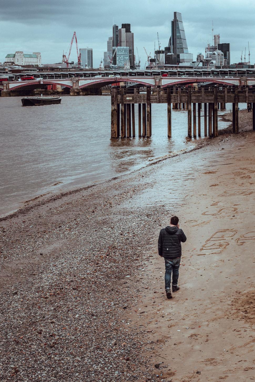 Free Image of Solitary man walking along river shore 