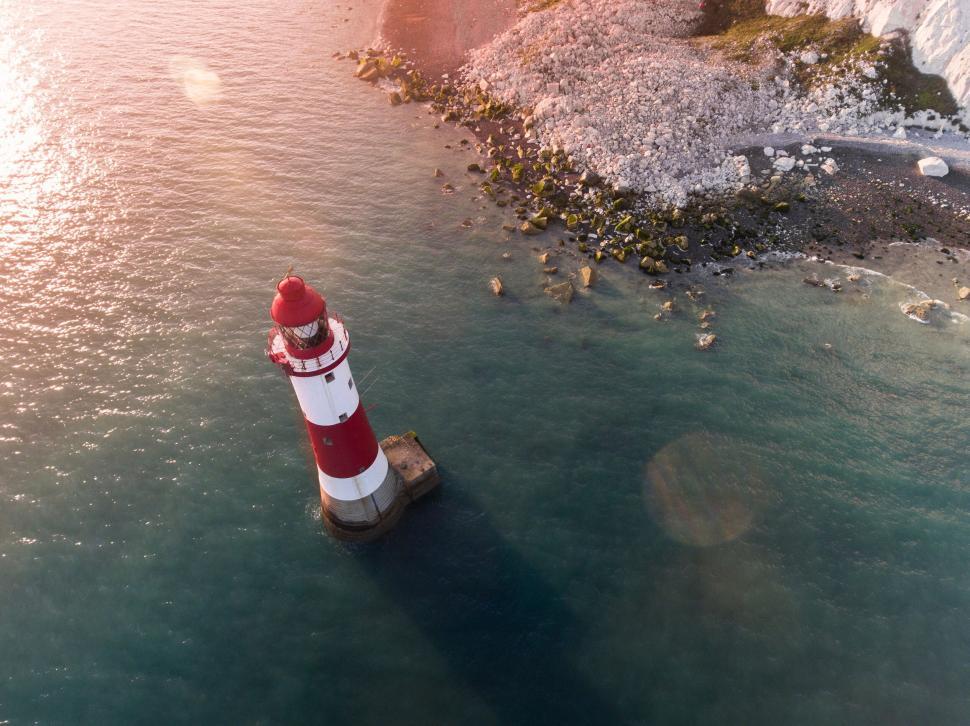 Free Image of Aerial view of lighthouse on a rocky island 