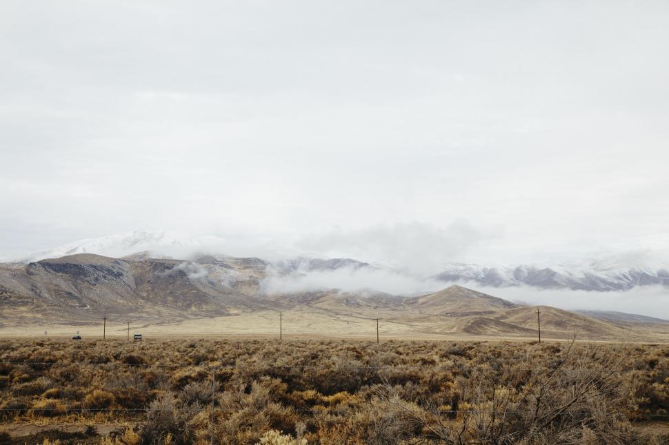 Free Image of Desert landscape with mountains and clouds 