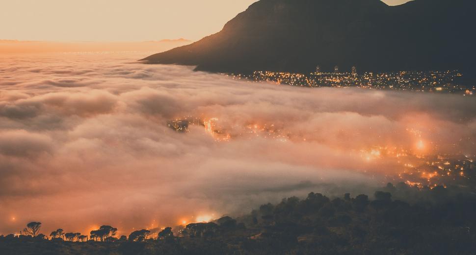 Free Image of Misty sunrise over a mountain town 