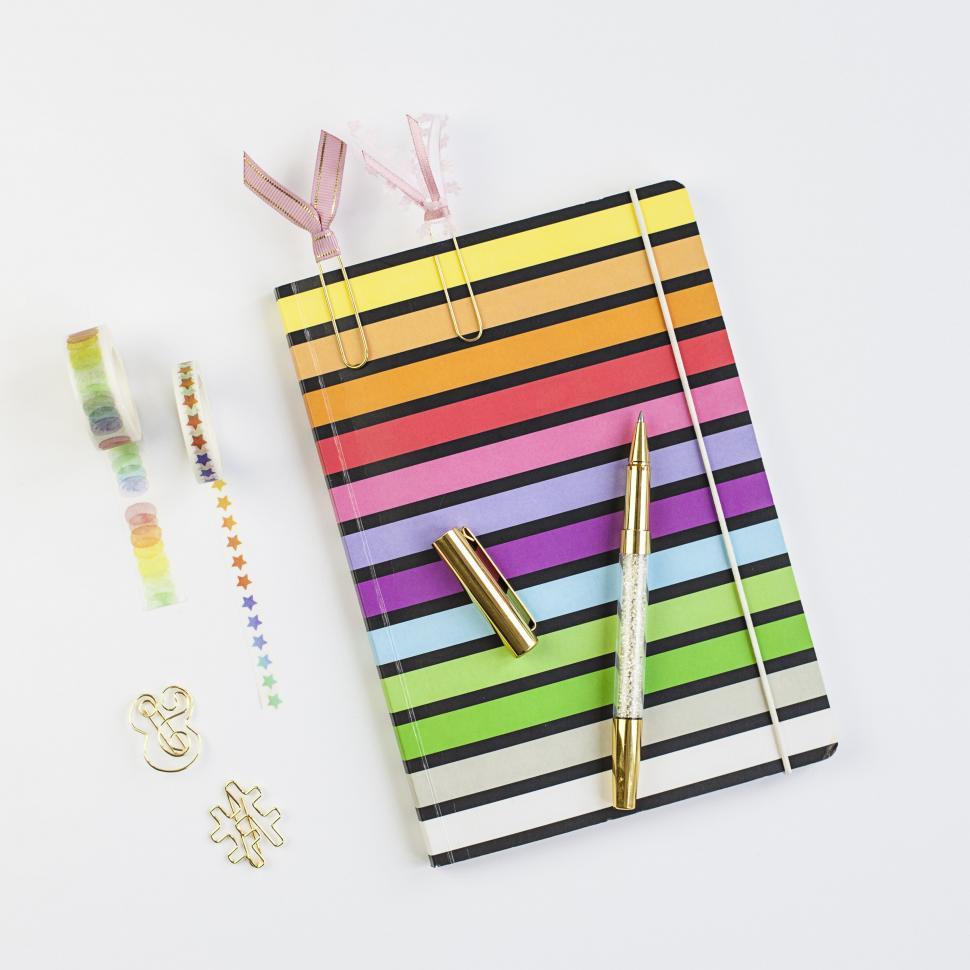 Free Image of Vibrant striped notebook and stationary items 