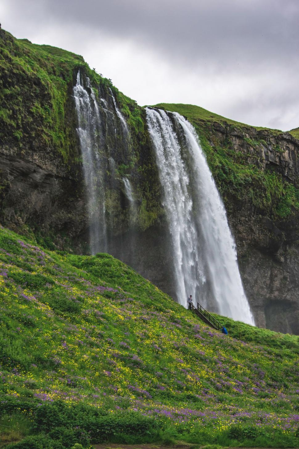 Free Image of Vibrant waterfall cascading down a cliff 