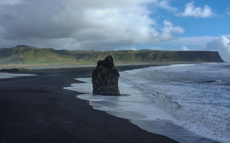 Free Image of Rocky monolith on a black sand beach 