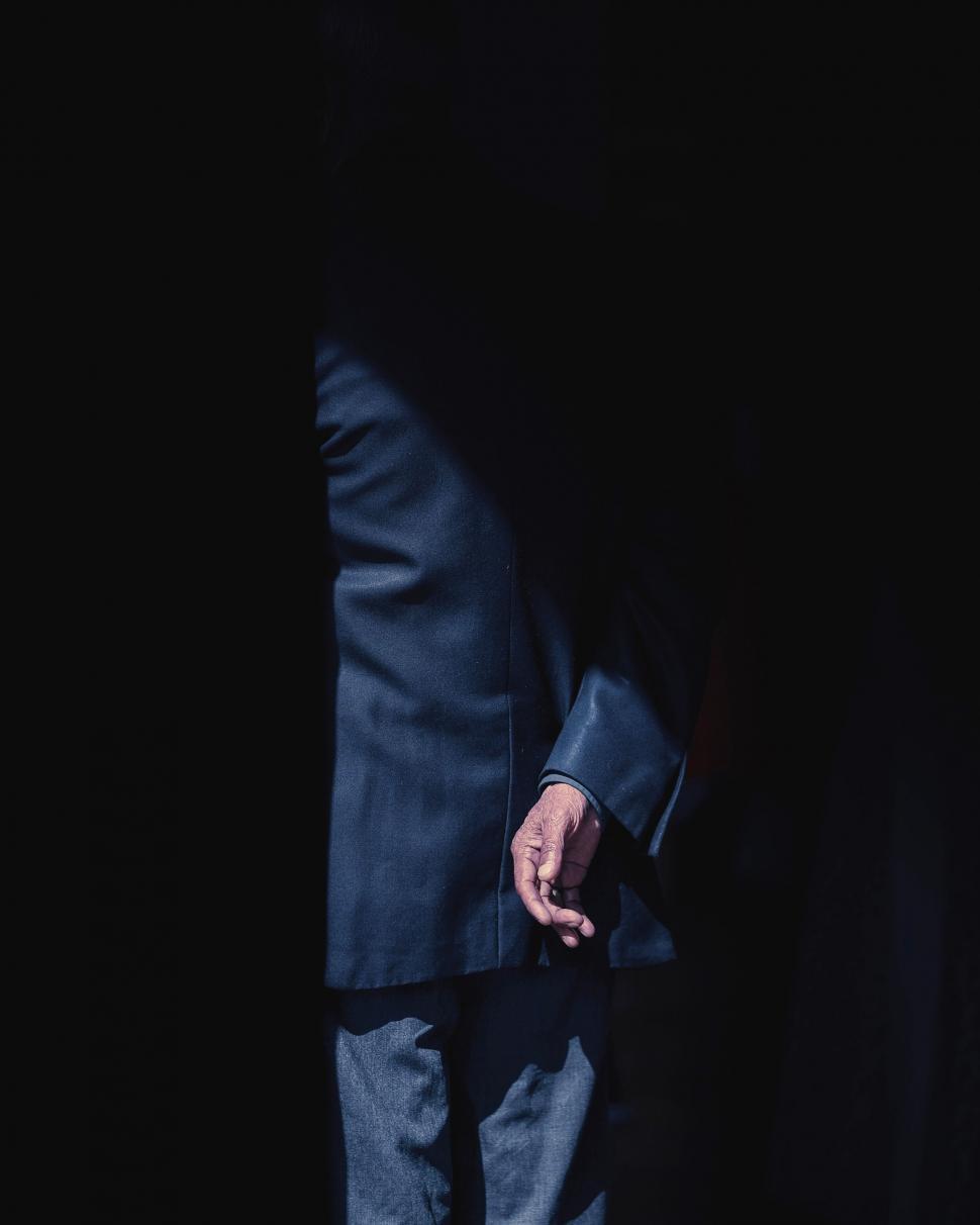 Free Image of Detail of person in suit with dramatic light 