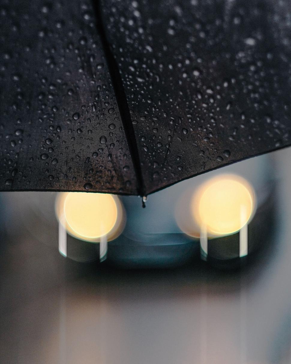Free Image of Close-up of raindrops on a black umbrella 