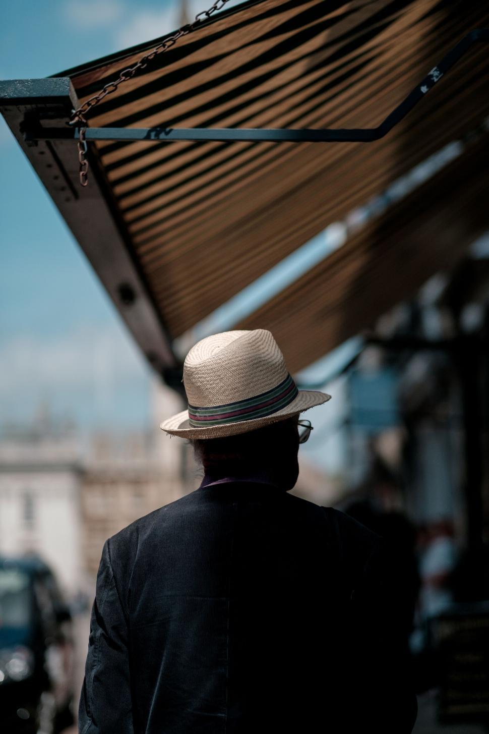 Free Image of Man in hat from behind in urban setting 