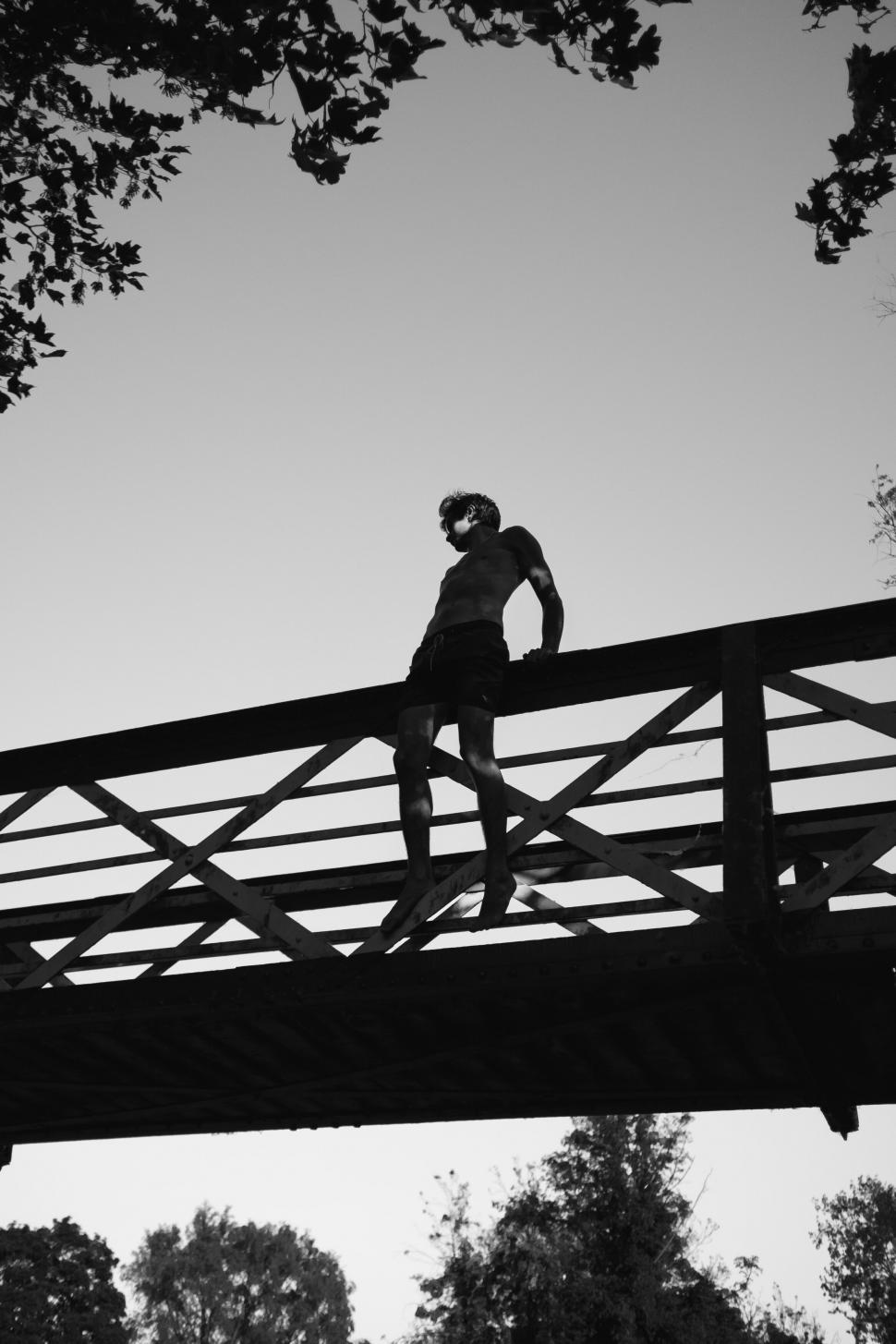 Free Image of Silhouette on bridge in black and white 
