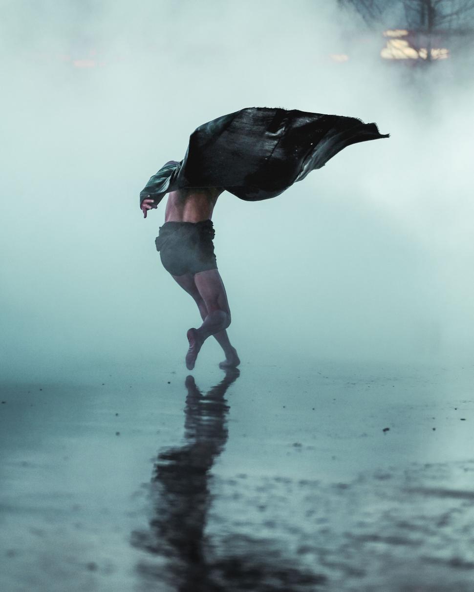 Free Image of Dancer in motion amidst dramatic fog 