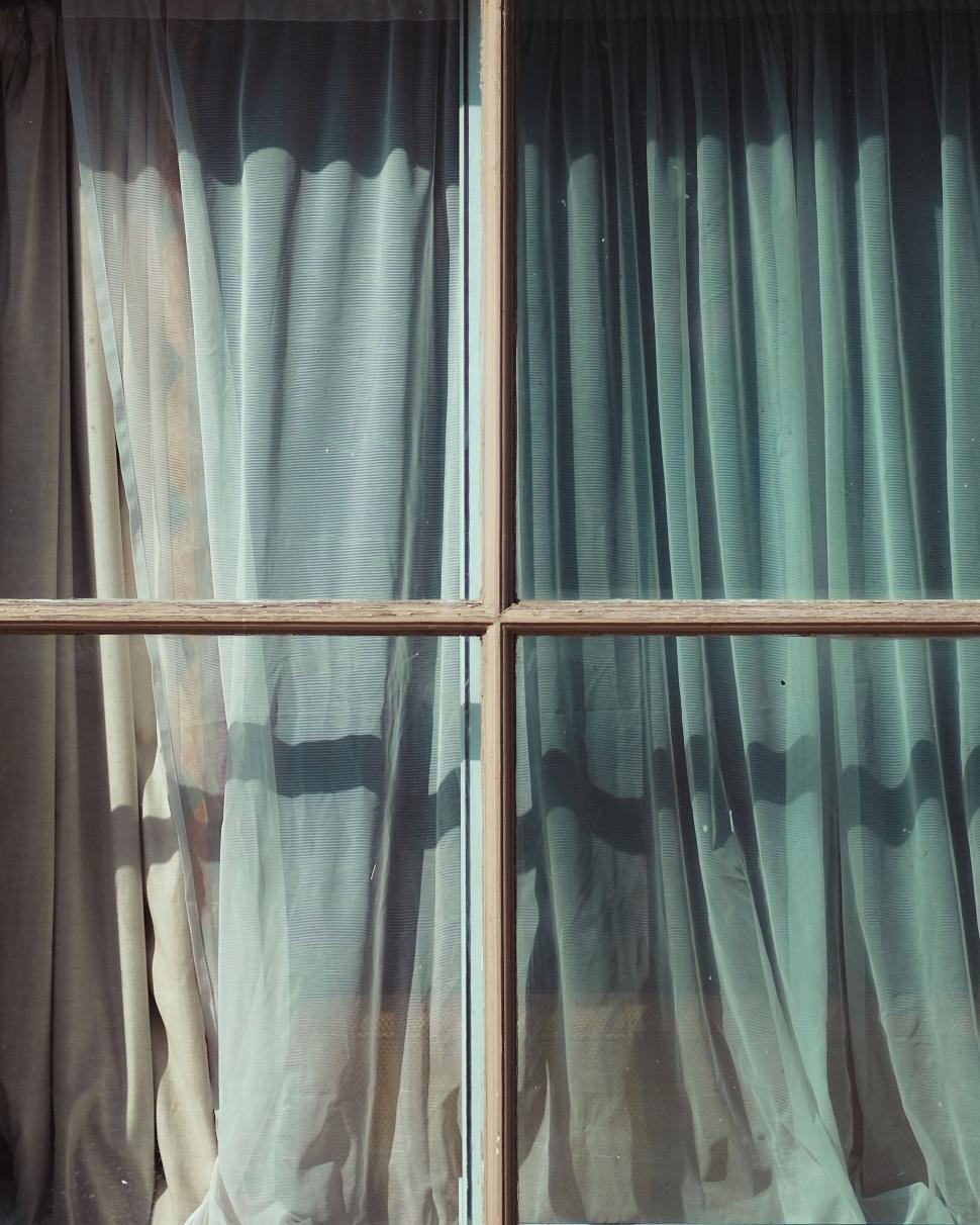 Free Image of Vintage style window with blue curtains and shadows 