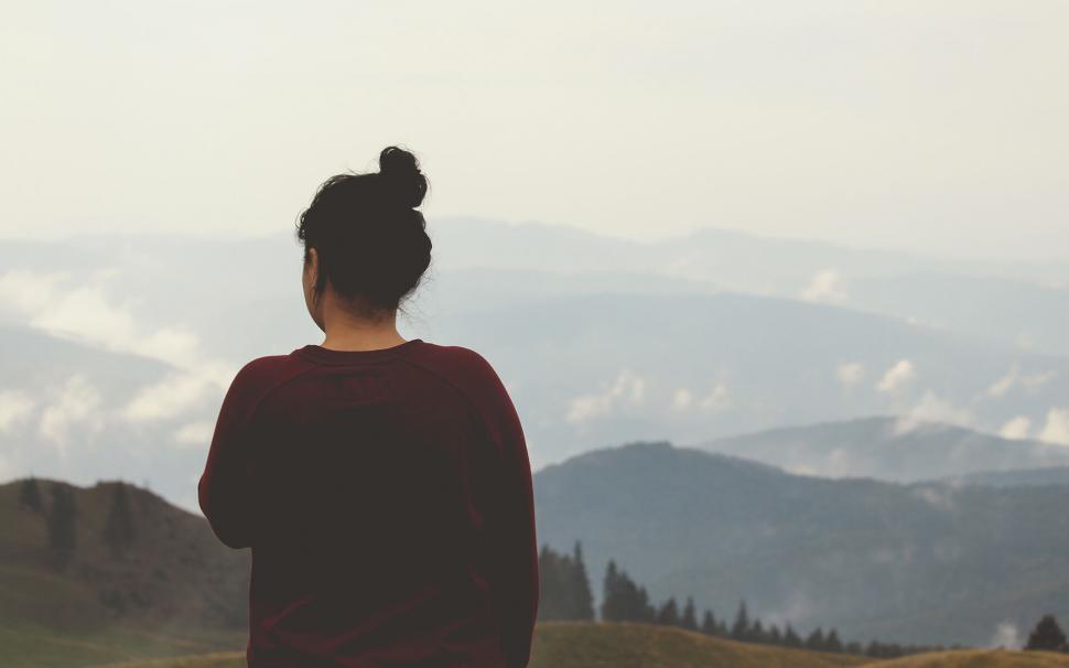 Free Image of Woman gazing at mountainous horizon in contemplation 