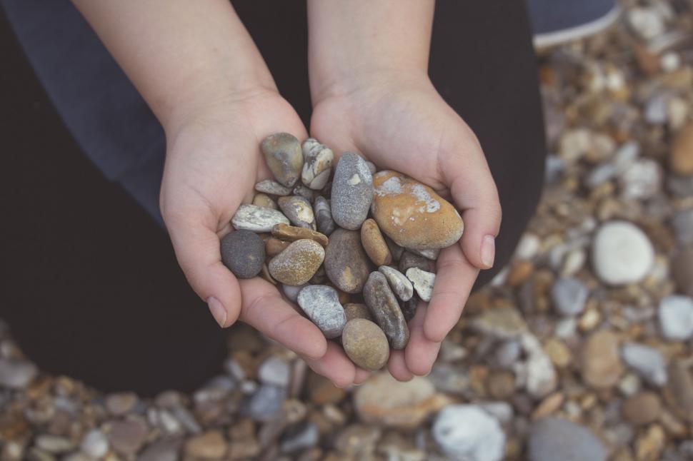 Free Image of Hands holding a variety of stones 
