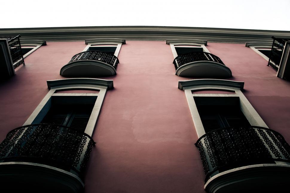 Free Image of Facade of a pink building with balconies 