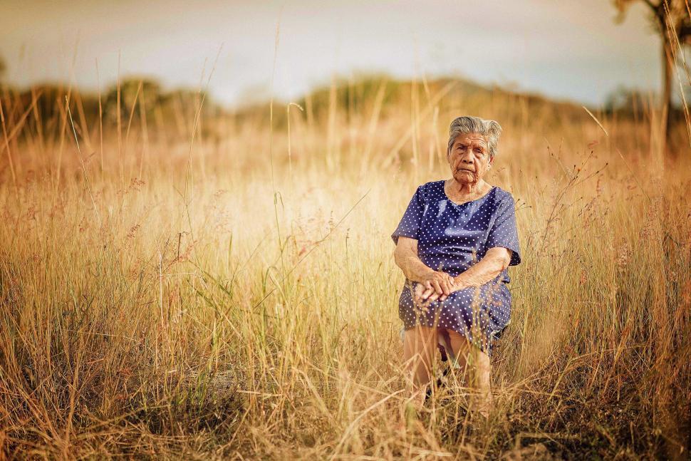 Free Image of Elderly lady in a desolate field 