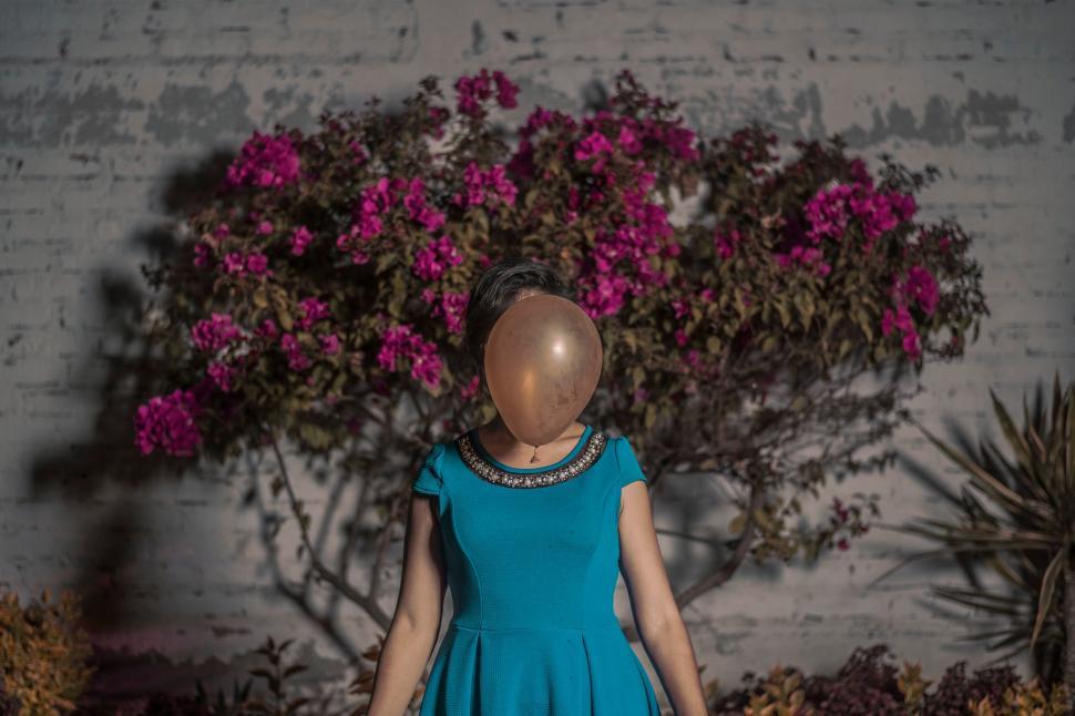 Free Image of Woman with balloon head in floral scenery 