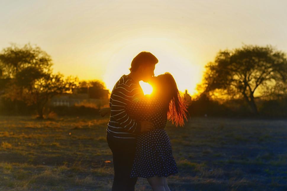 Free Image of Couple embracing at sunset silhouette 