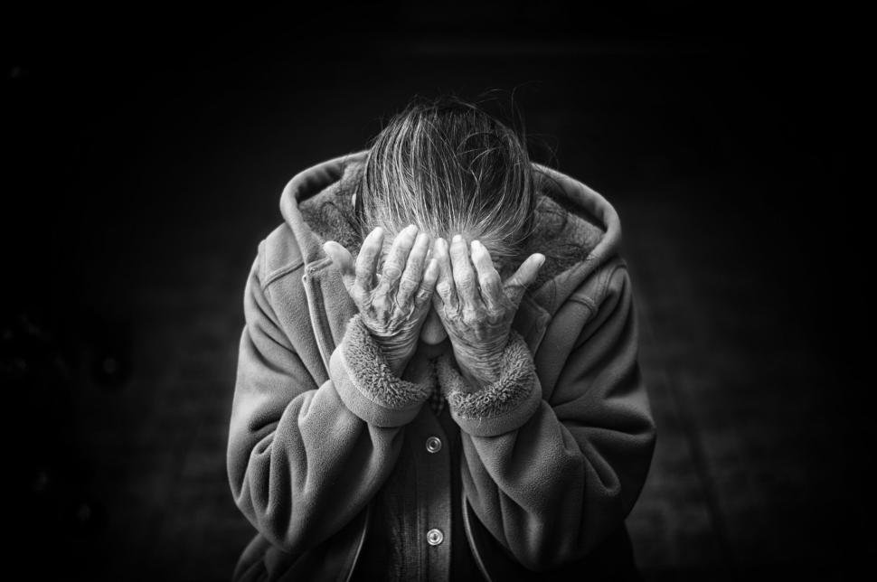 Free Image of Elderly woman covering her face 