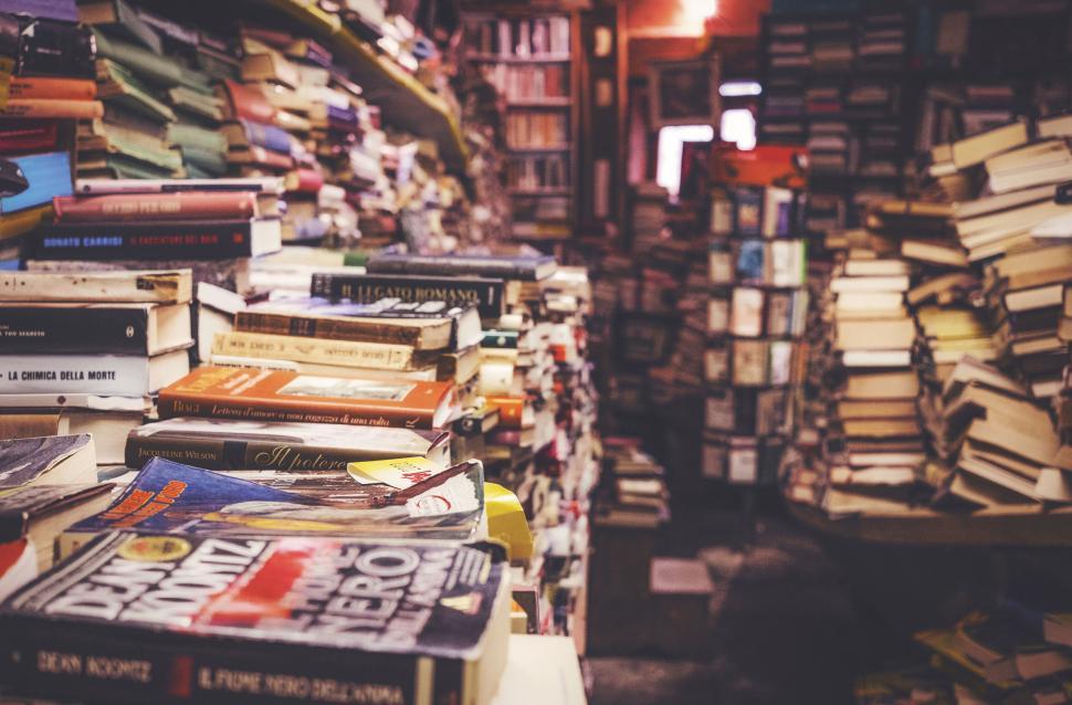 Free Image of Overflowing bookstore with piles of books 